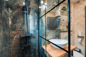 a bathroom with a glass shower with a sink at Ilmar suites - new in Cluj-Napoca +45 photos