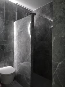 a bathroom with a toilet and a shower at Remezzo in Koutalás +17 photos