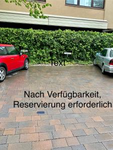 two cars are parked in a parking lot at Kristall, Doppelzimmer mit Balkon in Toplage, Zentrum in Bad Ischl +9 photos