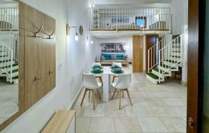 a dining room with a table and chairs and stairs at 2 Bedroom Amazing Home In Siracusa in Siracusa