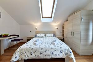 a bedroom with a bed and a skylight at Room Marica Baska in Baška +19 photos