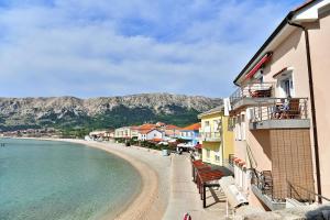 a view of a beach next to a building at Room Marica Baska in Baška
