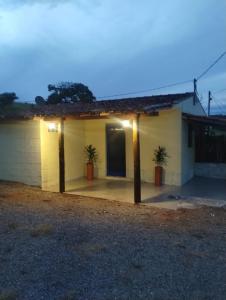 a building with two palm trees in front of it at Cantinho da Paz in Socorro