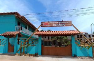 a blue building with a sign in front of it at Pousada e Restaurante Cenário in Marau