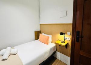 a hotel room with a bed and a lamp on a table at Autentic Boutique Moncloa in Madrid