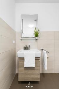 a bathroom with a white sink and a mirror at Ferienwohnung Bude 5 Dagebüll in Dagebüll