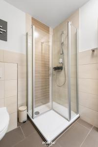 a shower with a glass door in a bathroom at Ferienwohnung Bude 5 Dagebüll in Dagebüll