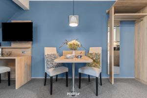 a dining room with a table with chairs and a tv at Ferienwohnung Bude 5 Dagebüll in Dagebüll