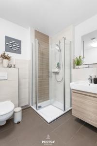 a bathroom with a shower and a toilet and a sink at Ferienwohnung Bude 6 Dagebüll in Dagebüll