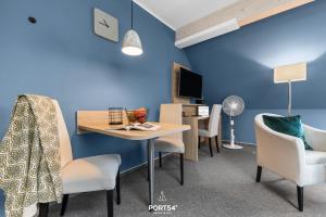 a room with a table and chairs and a blue wall at Ferienwohnung Bude 6 Dagebüll in Dagebüll