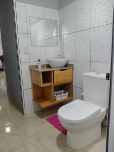 a bathroom with a white toilet and a sink at Departamentos Alta Vista 1 in Dos de Mayo