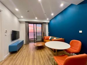 a living room with a table and a couch at Hillside Luxury Apartments by CASEPIA in Phu Quoc