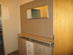 ヴァイセンシュタットにあるNEU! Reiterhof Finkenmühle Fewo Romano mit Balkonの木造のキャビネットの横の壁面鏡