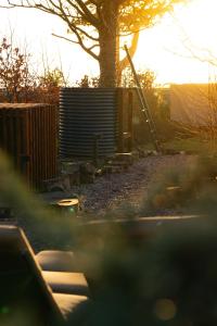 a fence with a tree and a tree at Gileston Manor-Self catering in Saint Athans