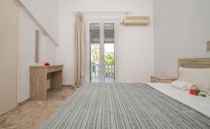 a bedroom with a large bed and a window at Markella Maisonette Hotel Complex in Marathias +18 photos