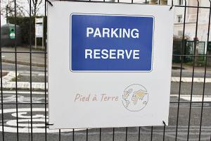 a sign for a parking preserve on a fence at Pied à terre - Mezzanine studio - Private parking in Irigny
