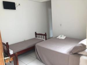 Pousada Simples José客房内的一张或多张床位