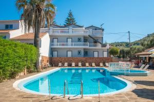 a swimming pool in front of a large building at Markella Maisonette Hotel Complex in Marathias