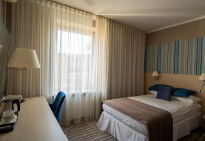 Posteľ alebo postele v izbe v ubytovaní Hotel Cristal Białystok