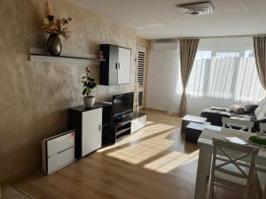 a living room with a couch and a television at Perspective View in Veliko Tŭrnovo