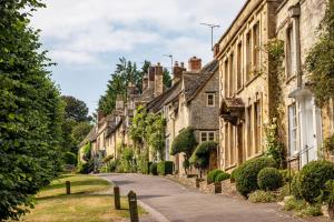 a row of stone houses on a street at Upper End House in Shipton under Wychwood