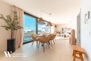 a dining room with a table and chairs at Higueron West Property Collection - La CostaVale by HWPC in Fuengirola