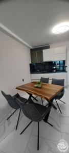 a dining room with a wooden table and chairs at Magic Home in Obzor