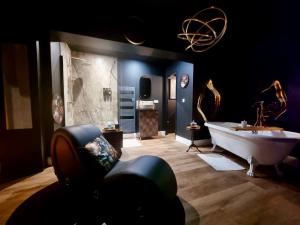 a large bathroom with a tub and a claw foot bath tub at Love Room La Croix de Saint André in Saint-André-de-Cubzac