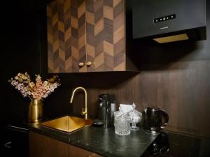 a kitchen counter top with a sink and a counter top at Love Room La Croix de Saint André in Saint-André-de-Cubzac