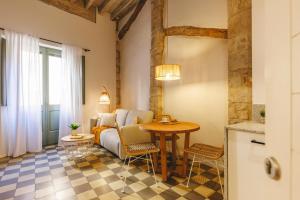 a living room with a couch and a table at Bravissimo Calderers La Lleona, heart of the Barri Vell in Girona +13 photos