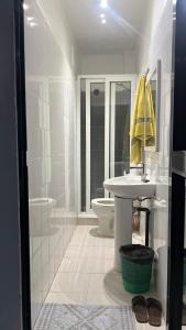 a white bathroom with a sink and a toilet at RESIDENCE ADSL Studio Dakar in Dakar