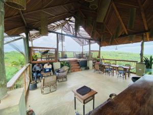 two people sitting in a pavilion with tables and chairs at Boko Boko Guesthouse in Busua