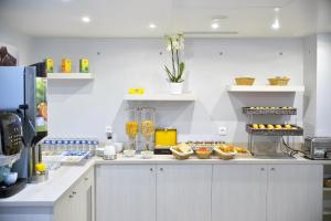 a kitchen with a counter with food on it at Hôtel Eugénie in Paris