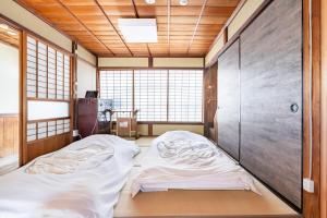 Manabi-stay Matsue客房内的一张或多张床位