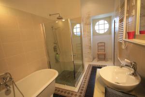 a bathroom with a shower and a toilet and a sink at Abbaye de Reigny - Esprit de France in Vermenton +46 photos