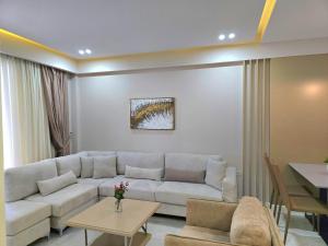 a living room with a white couch and a table at Lura 3 Holiday Homes 178 in Lalzit Bay