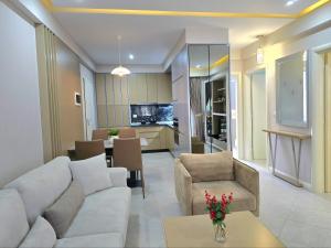 a living room with a couch and a dining room at Lura 3 Holiday Homes 178 in Lalzit Bay