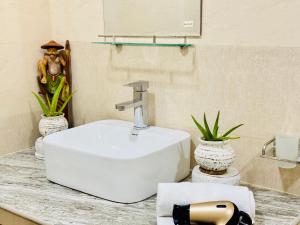 a bathroom with a white sink on a counter at EIT Masky Villa in Ambalangoda +46 photos