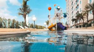 a pool in the middle of a building with a playground at Salinas Park Resort in Salinópolis
