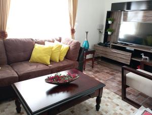 a living room with a couch and a table at Casa castro chiloe in Castro