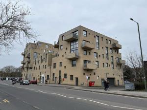a large building on the side of a street at Balcony Breeze Modern 2-Bedroom in Colindale