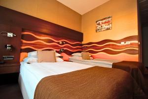 Postel nebo postele na pokoji v ubytování Danubia Gate Hotel