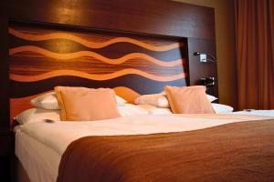 Postel nebo postele na pokoji v ubytování Danubia Gate Hotel