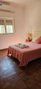 a bedroom with a bed with a red blanket on it at Casa belgrano Lobos in Lobos