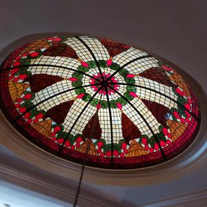 a stained glass window on top of a ceiling at Castle Garden in Szombathely +10 photos