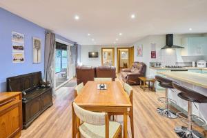 a kitchen and living room with a table and chairs at Host & Stay - Dovecote View in Aylsham +12 photos