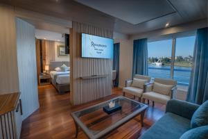 a living room with a couch and a tv at Renaissance Nile Cruise - Every Saturday from Luxor To Aswan for 4 Nights , and every Wednesday from Aswan To Luxor for 3 Nights in Luxor