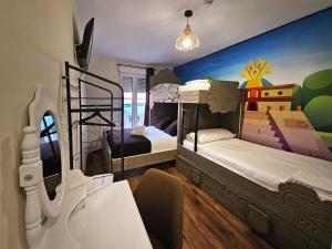 a bedroom with two bunk beds with a mural at El Indio Chocolatería Boutique in Pinto