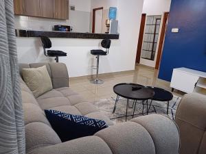 a living room with a couch and a table and chairs at Havy Homes 2 in Bamburi