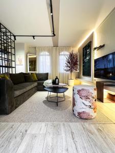 a living room with a couch and a table at 6th Of October Signature Stay in 6th Of October